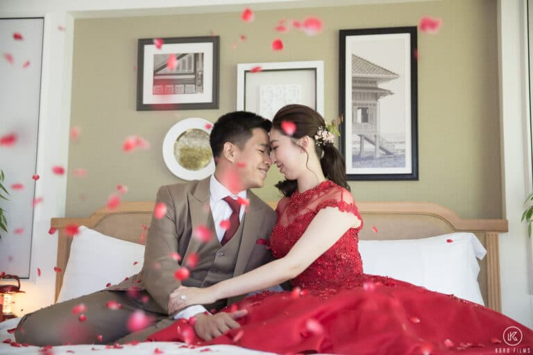 Rose petals fall on the bride and groom in their room at Dusit Thani Hua Hin