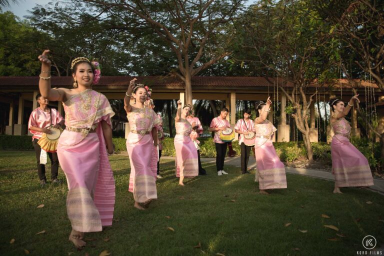 Dancers in pink Thai costume and long-drum players lead the Khan Maak procession through the gardens of Dusit Thani Hua Hin