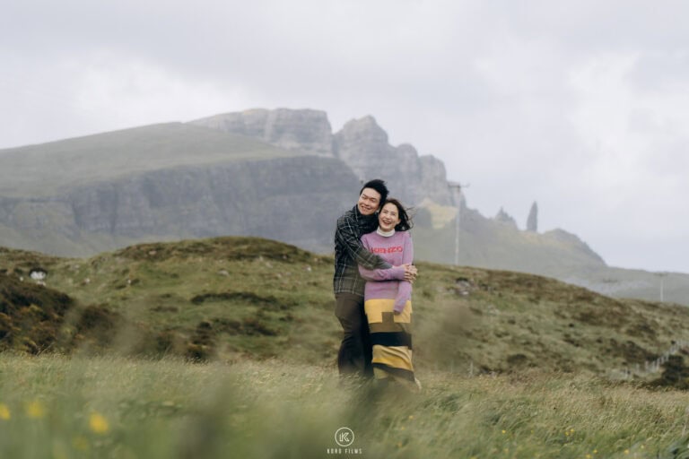 Kit and Ky hug on a misty hillside on the Isle of Skye, Scotland