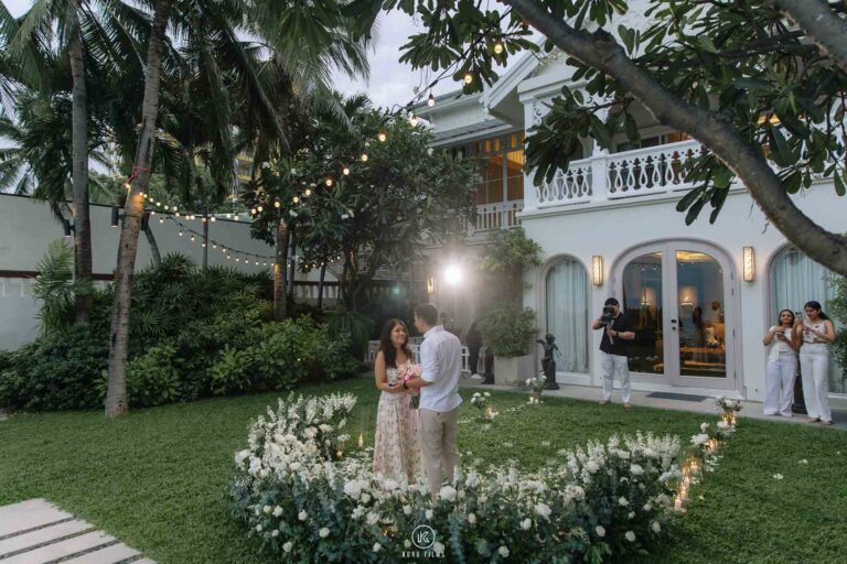 Vatsal and Paridhi walk through the villa garden under string lights at dusk, InterContinental Hua Hin