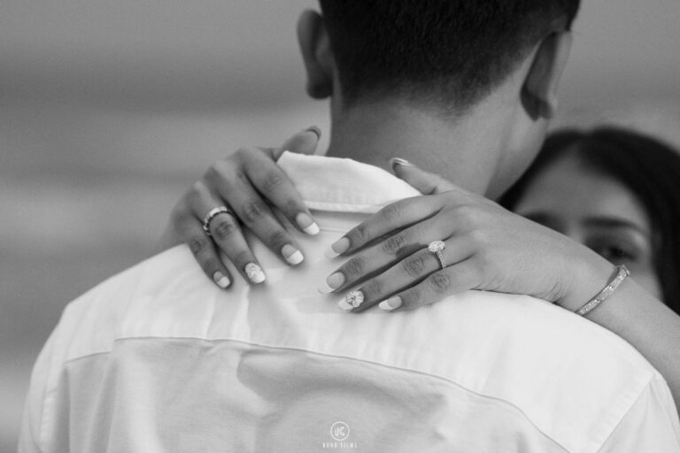 Black-and-white close-up of the engagement ring as Paridhi rests her hand on Vatsal’s shoulder