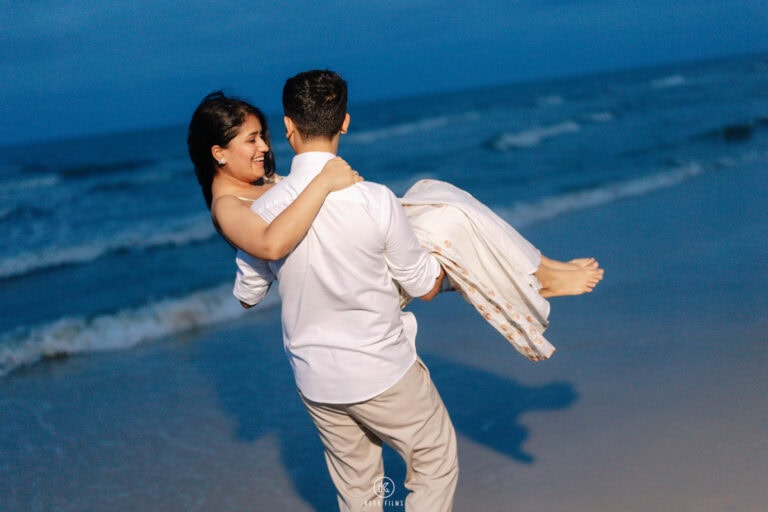 Vatsal carries Paridhi on the beach in Hua Hin at blue hour