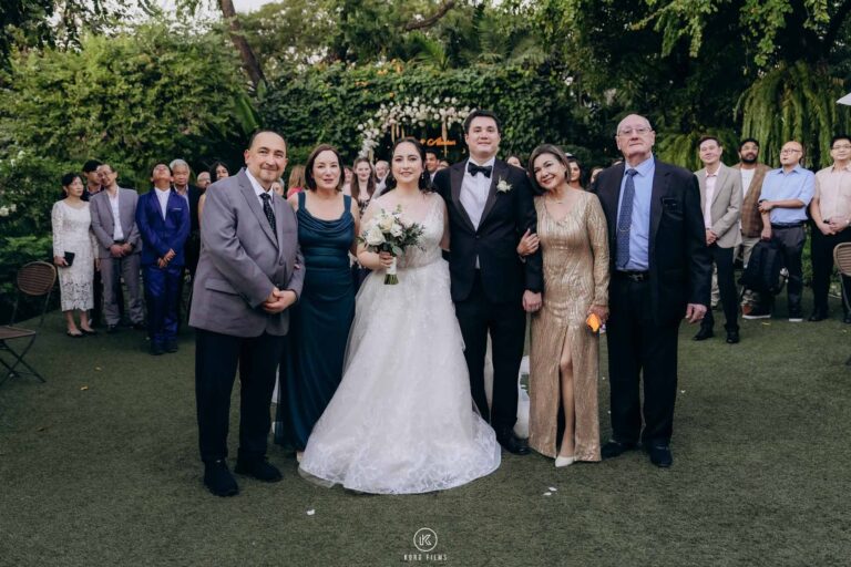 Tara and Alastair with their families on the lawn after the ceremony at The Botanical House, Bangkok