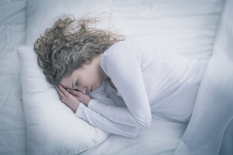 This image shows a girl is sleeping on the bed