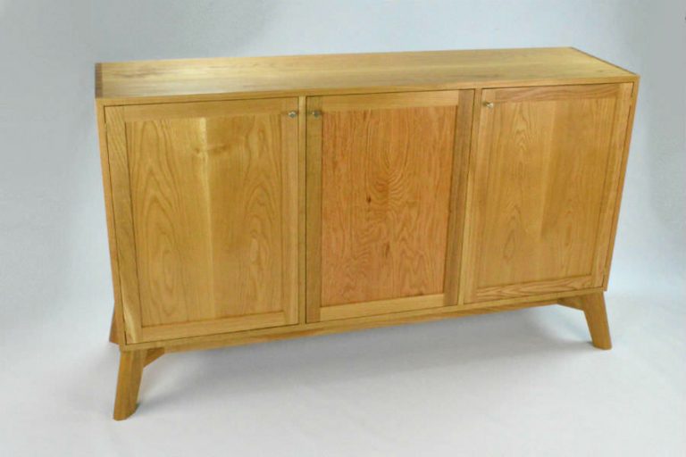 Intersection Cabinet. White Oak Cabinet with Book Matched Panel Doors. Hand cut Dovetails carcass for strength. The angle legs give a strong stable base. The line is offered as a sideboard/buffet, low and tall media consoles, storage consoles, and small sideboard. Custom made timber furniture. Custom made furniture and furniture maker.