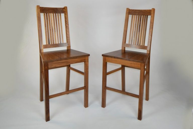 A custom-made order for this pair of bar stools that a customer wanted to match a pair of rock maple stools they had from their time in the U.S.A Made From Black Walnut and finished in clear satin poly.