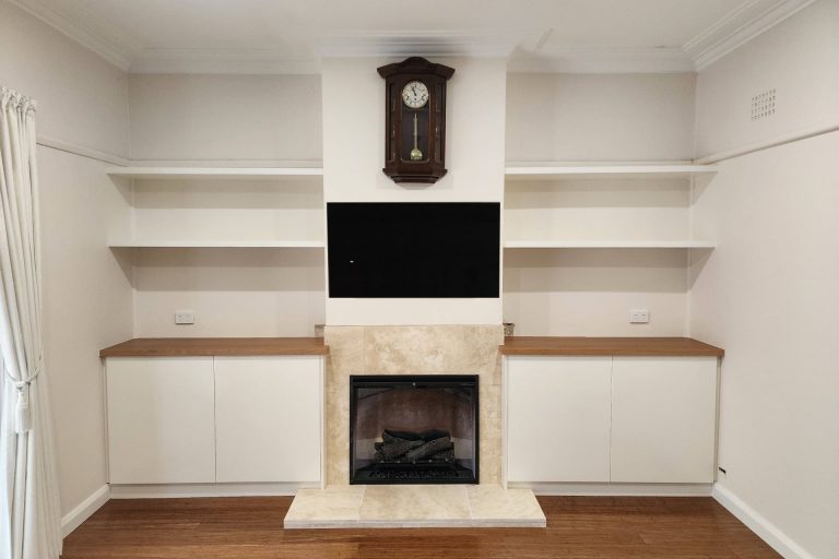 Custom Alcove Cabinets for a Turramurra Home We designed and built a beautiful set of custom alcove cabinets for a customer in Turramurra. These cabinets have blackbutt veneer for the countertops which match free float shelves and cabinets which are painted in a soft cream-colored poly paint. The cabinets are on either side of a central integrated TV unit and fireplace, maximizing the storage and display space in this area of the home. The alcove units have lovely free-floating shelves that provide open and airy storage solutions. Both the alcove units feature soft close doors with a smooth push-to-open mechanism, adding convenience. We specialize in hand-crafting custom cabinets that are designed specifically for our customer's homes and needs. Contact us today to discuss how we can create the perfect custom cabinets for your next project.