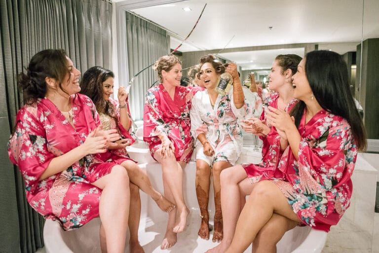 Bride and bridesmaids in matching floral robes getting ready