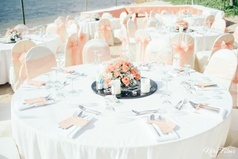 Round reception table with white linen and peach flowers at Cape Dara Resort, Pattaya
