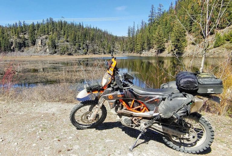 dual sport KTM motorcycle in front of a lake