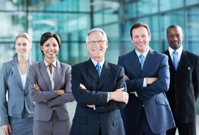 A group of people in suits and ties standing next to each other.