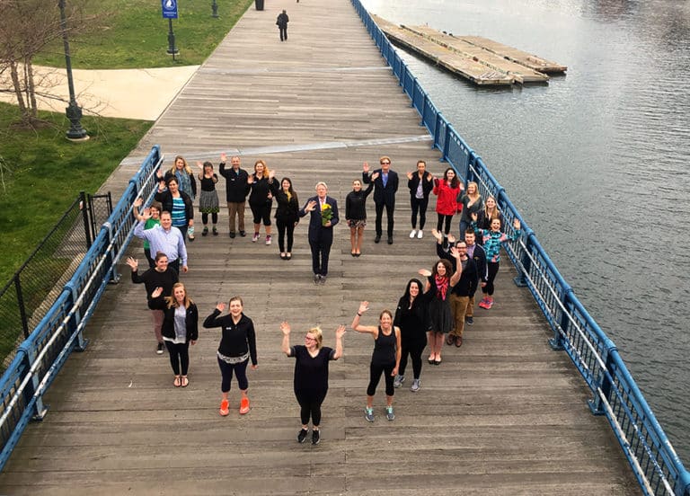 ACIS staff standing together to create a heart