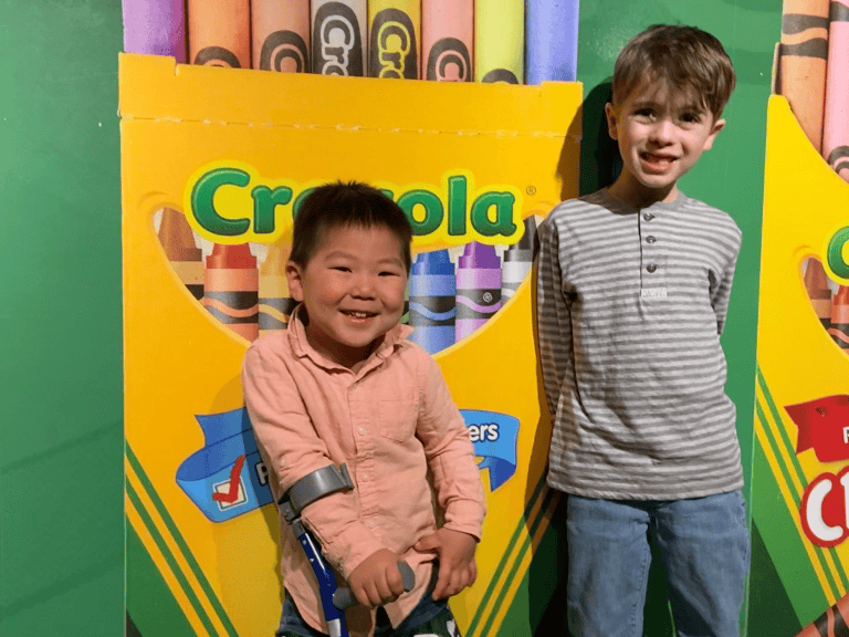 Kids in front of giant crayola crayons box