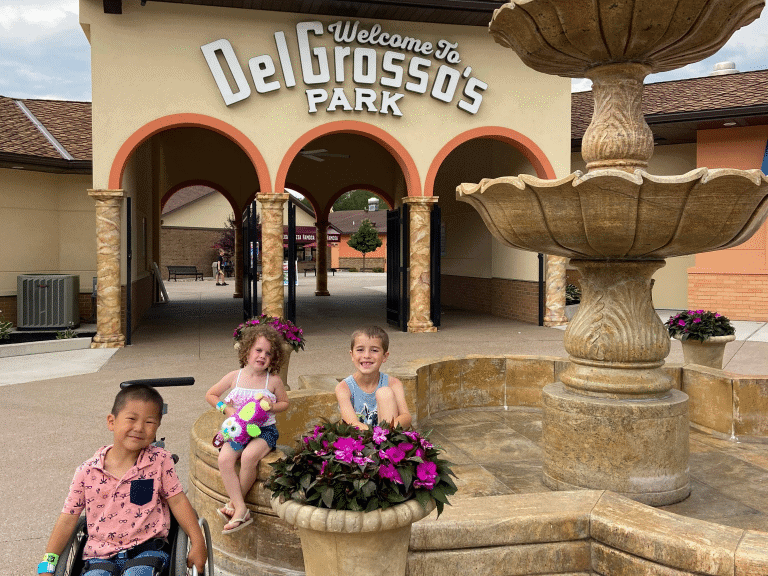 Children happy in front of the entry of Delgrosso's Park in pennsylvania