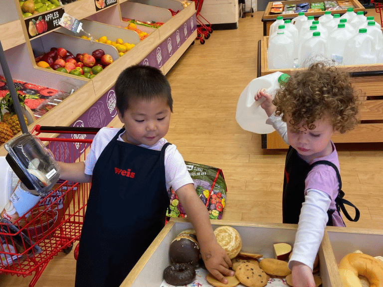 Lewisburg Children’s Museum two kids playing in the grocery exhibit