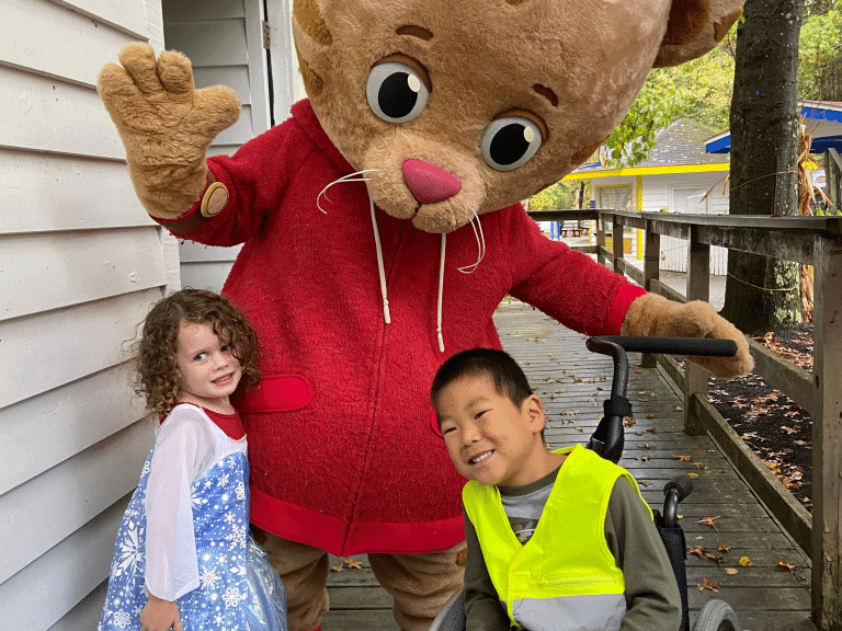 Kids posing with a mascot at Idlewild park