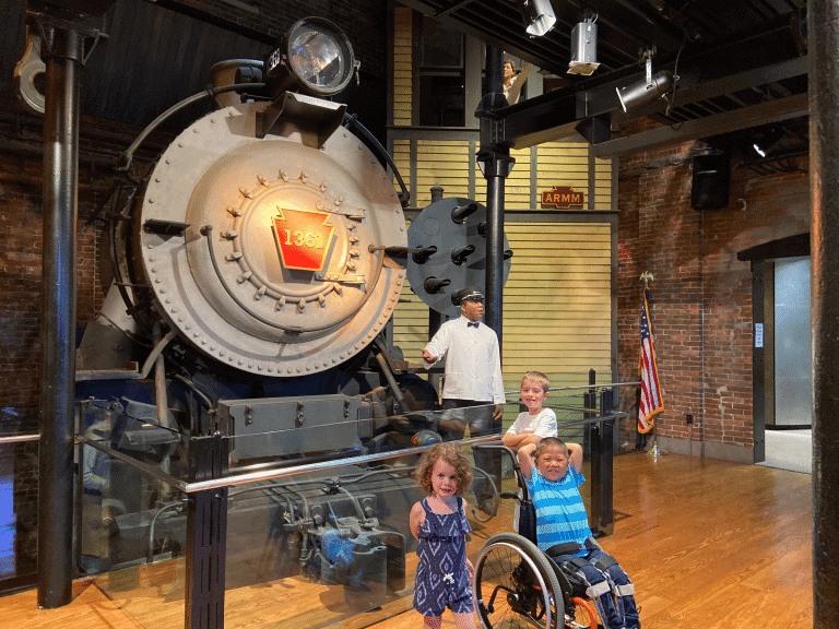 Railroad Museum indoor train display with three kids