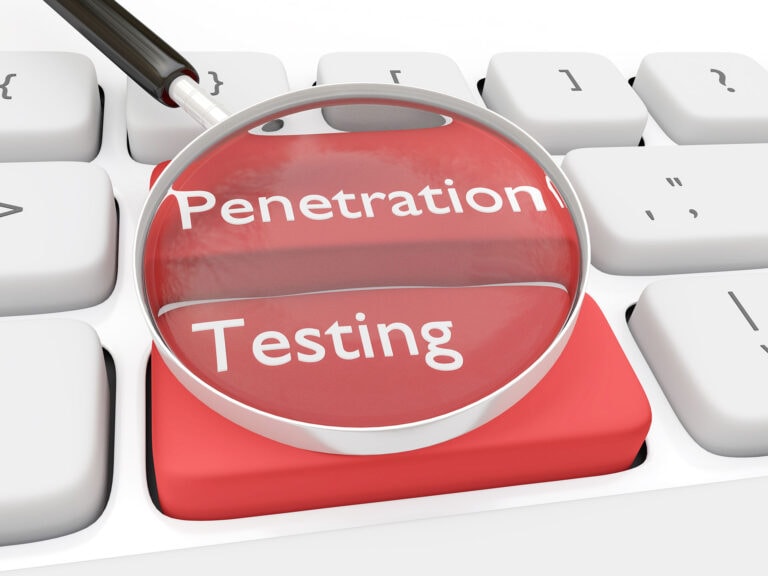 A keyboard with the words penetration testing and magnifying glass.