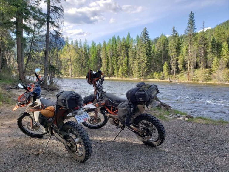 motorcycles loaded for camping by river