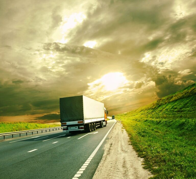 Commercial Trucking Services at Sunset A semi-truck driving on a highway at sunset, representing reliable trucking services and back-office support for your commercial trucking business.