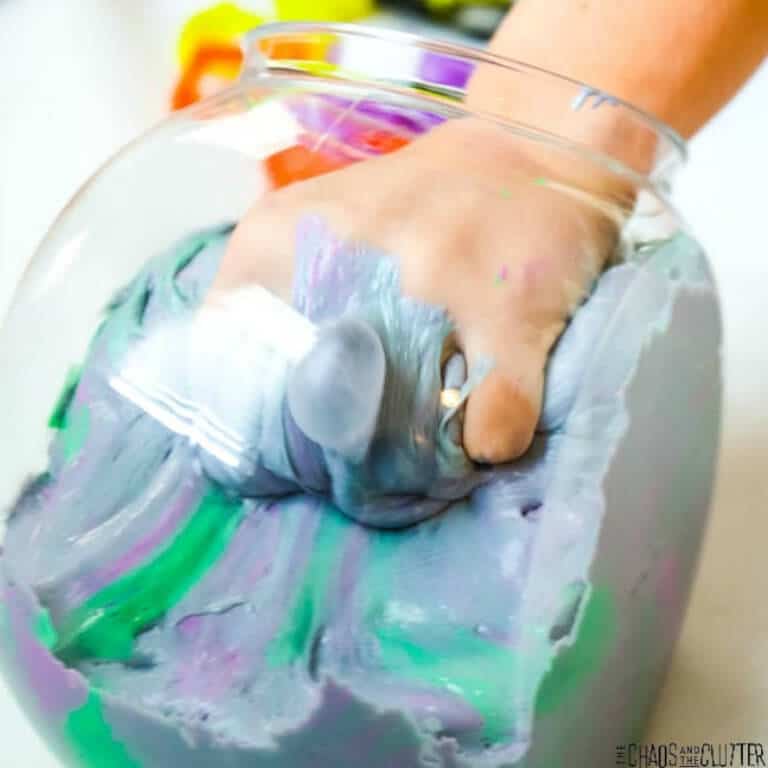 Halloween sensory bin with purple and green fluffy slime