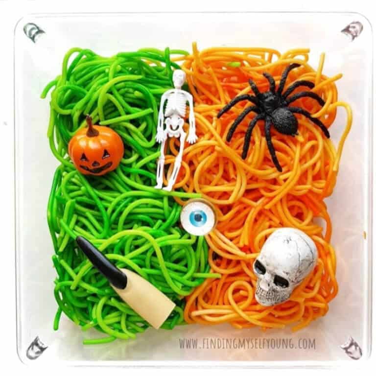 Halloween themed orange and green spaghetti sensory bin