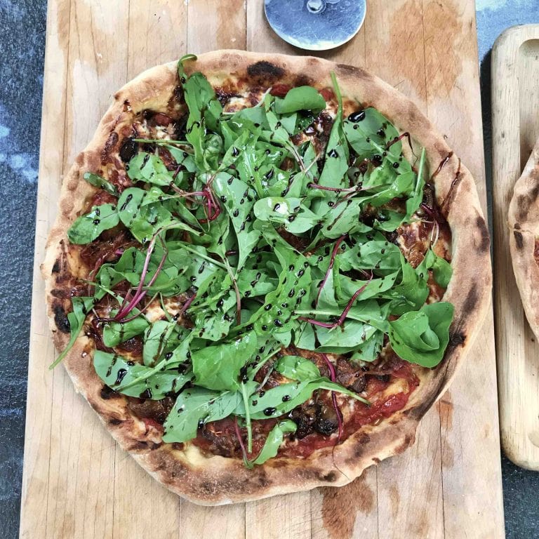 pizza roquette et prosciutto sur croûte de purée d'ail noi