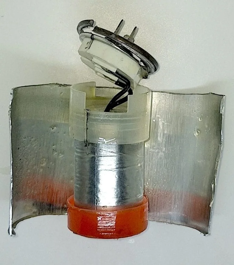 the internal components of a motor capacitor after the outer case is removed