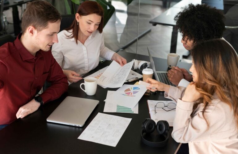 A group of people sitting around a table.