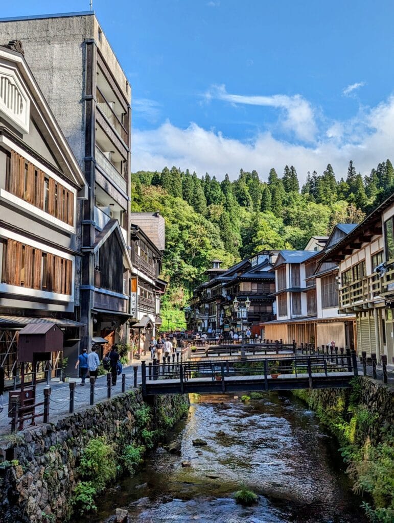 Historic wooden buildings lining the Ginzan Onsen river.