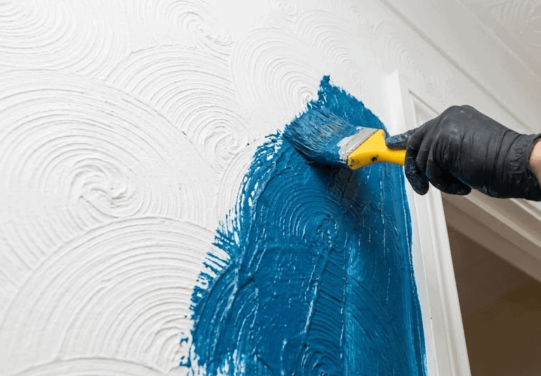 Applying sealant to a textured wall as a safety measure to Asbestos Encapsulation Grantham.