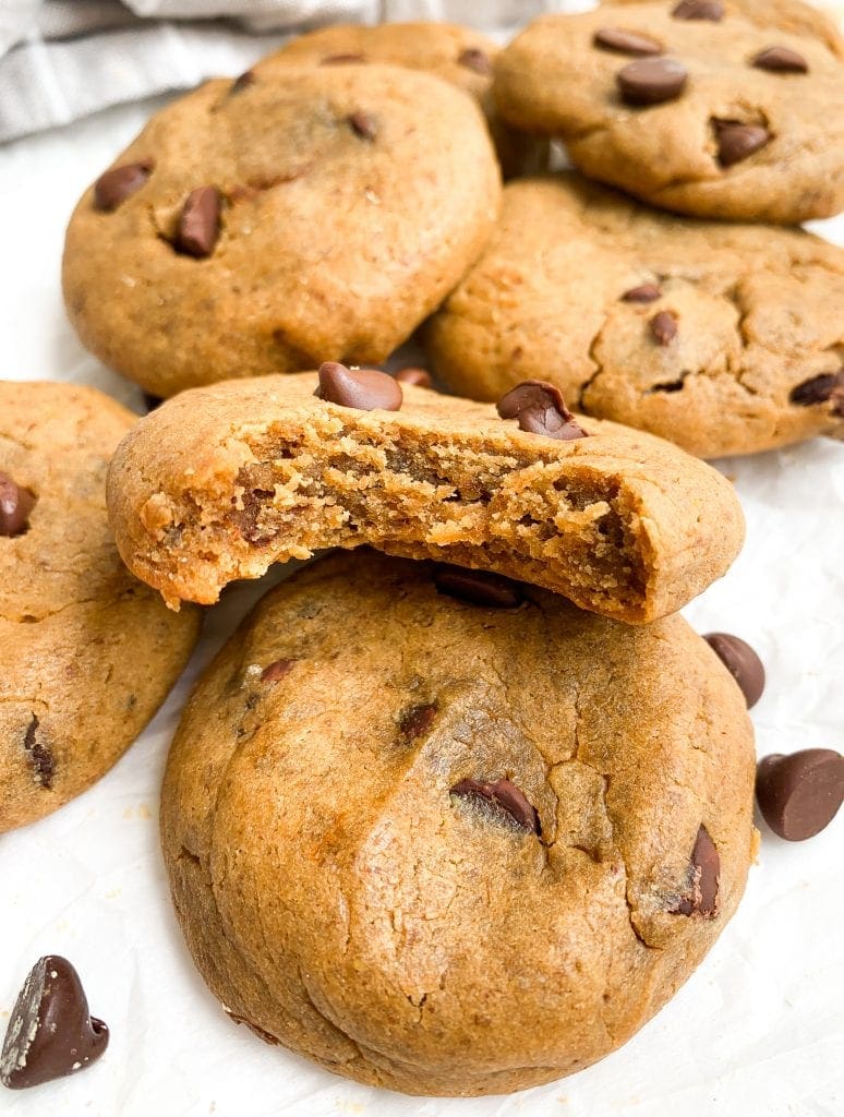 close up of protein cookies with chocolate chips after baking on a white background