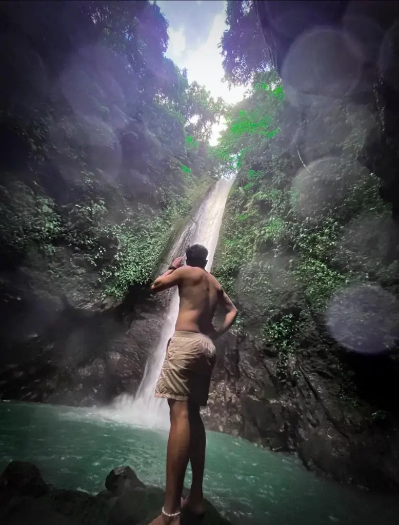 A picture of someone looking at the falls. The angle of the shot makes it seem somewhat distorted.