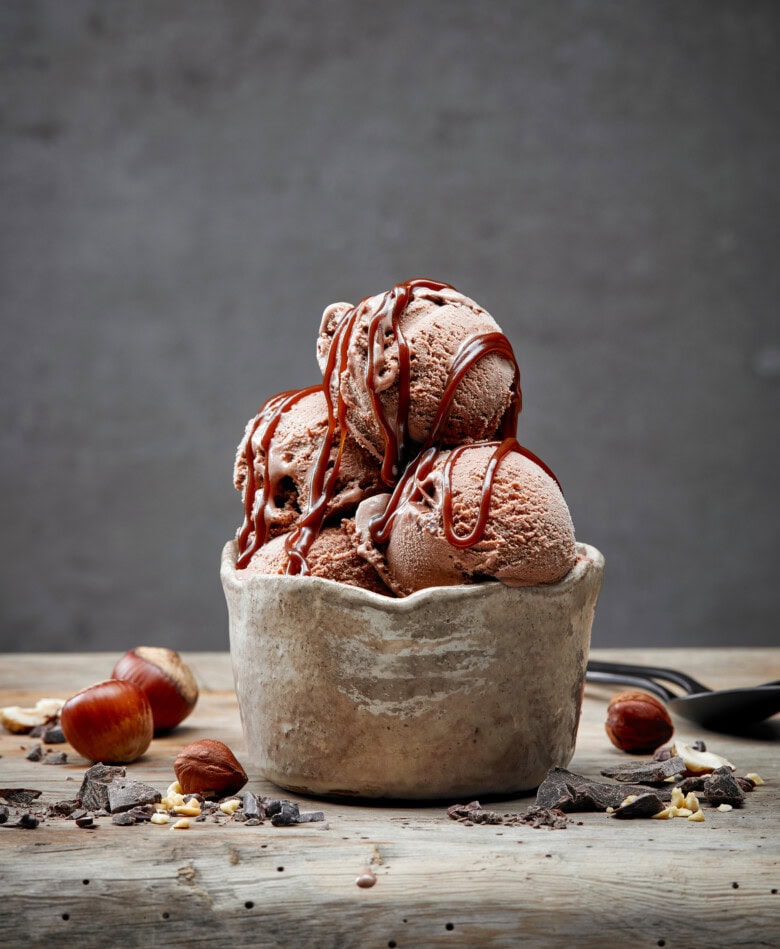 Chocolate And Hazelnut Ice Cream On Wooden Table