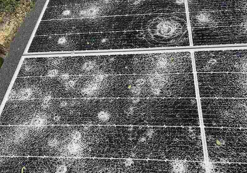 Hail-Damaged Solar Panel with Dents and Cracks Hail-Damaged Solar Panel with Dents and Cracks