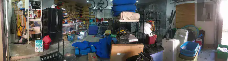 Storage and organization space filled with outdoor gear, bikes, and household items at Soulstice Living storage facility in a cluttered garage setting.