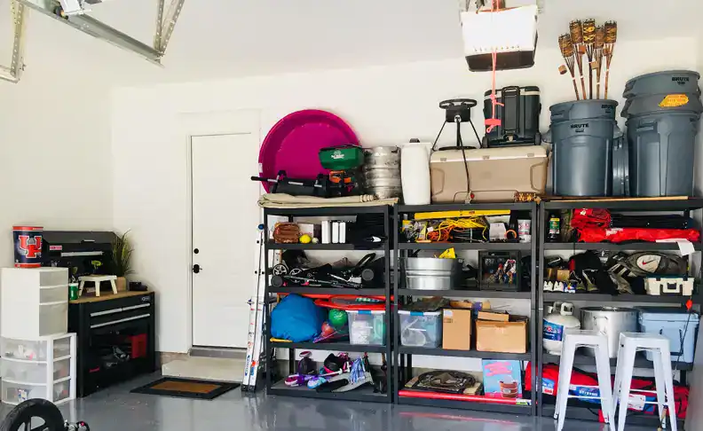 Garage storage organization with shelves and containers for outdoor gear, sports equipment, and gardening tools. Ideal for creating a clutter-free, functional space in your home. Perfect for home organization and storage solutions.