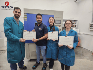 Technicians at European facility holding Testron Xenon Arc Weathering Chamber training certificate
