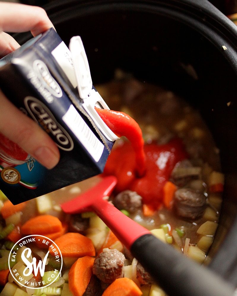 Passata being poured into the slow cooker