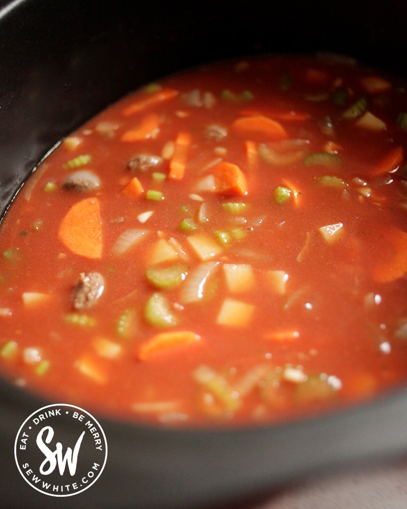 Slow cooker cooking the venison sausages