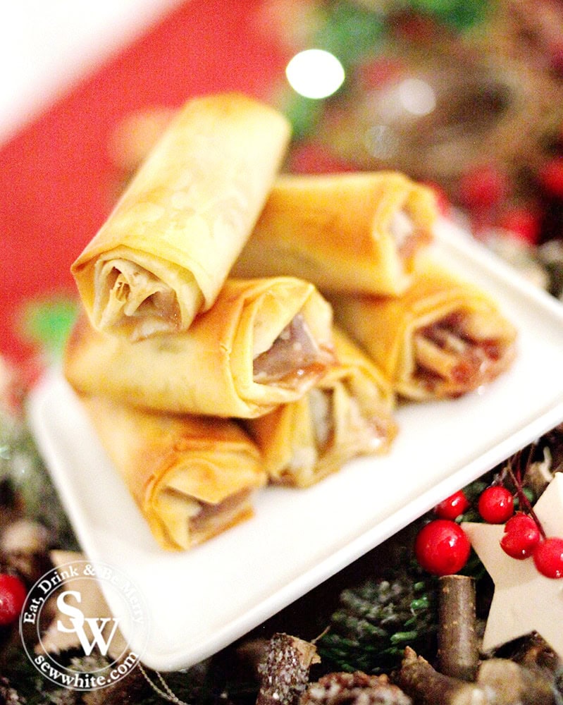 Golden brownbaked Mince Pie Rolls ready to be served on a while plate