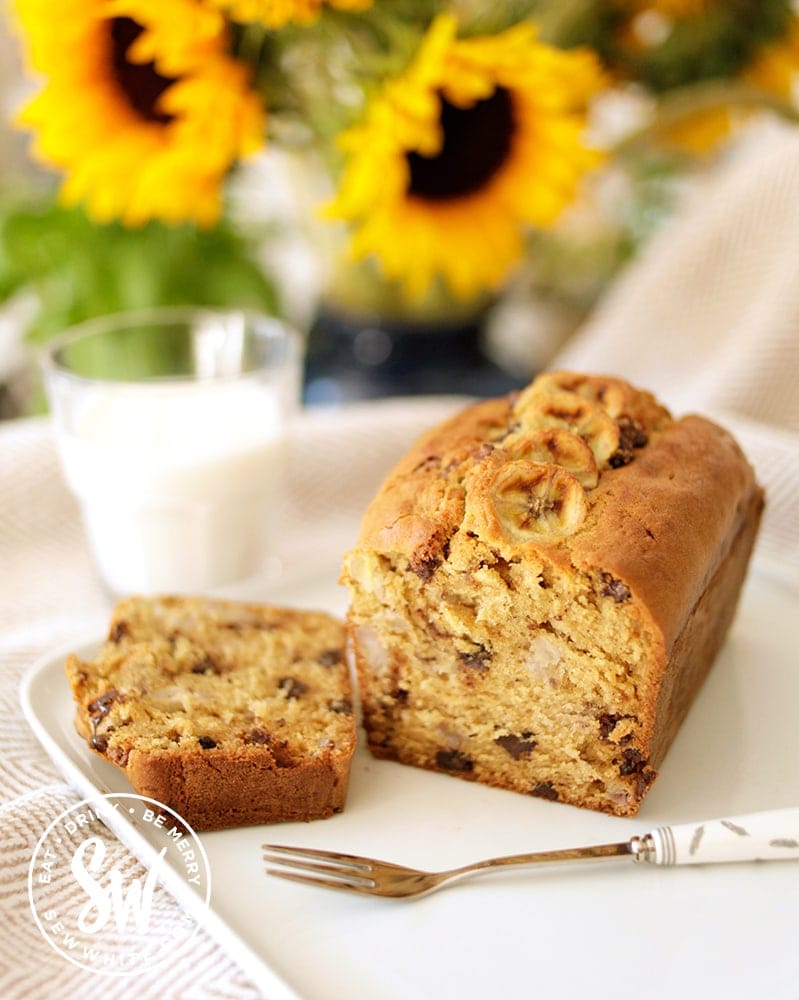 Banana Bread with Chocolate Chips on a plate with sunflowers