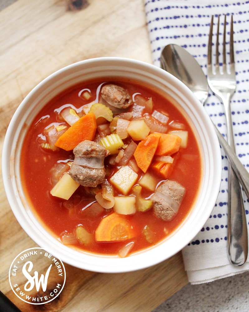 Slow Cooker Sausage Stew in a white bowl ready to be served