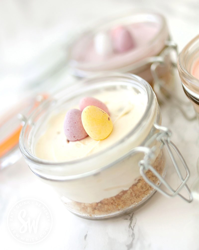 mini vanilla cheesecakes for Easter decorated with mini eggs