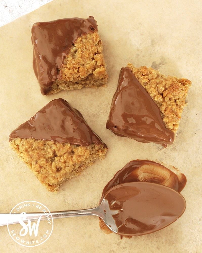 chocolate covered flapjacks on a piece of brown greaseproof paper