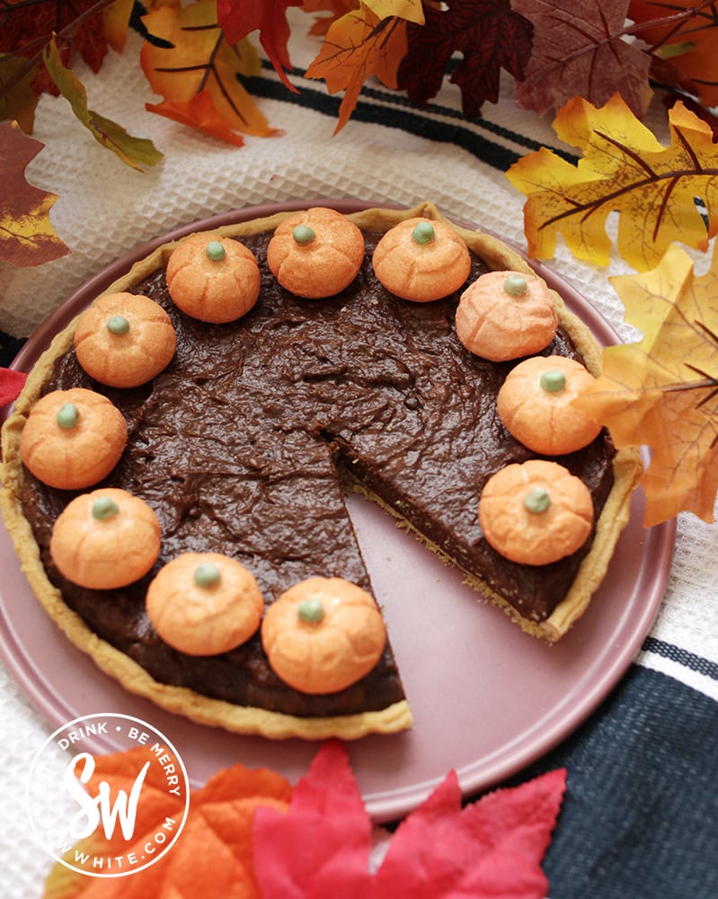 chocolate pumpkin pie with candy pumpkins on top.