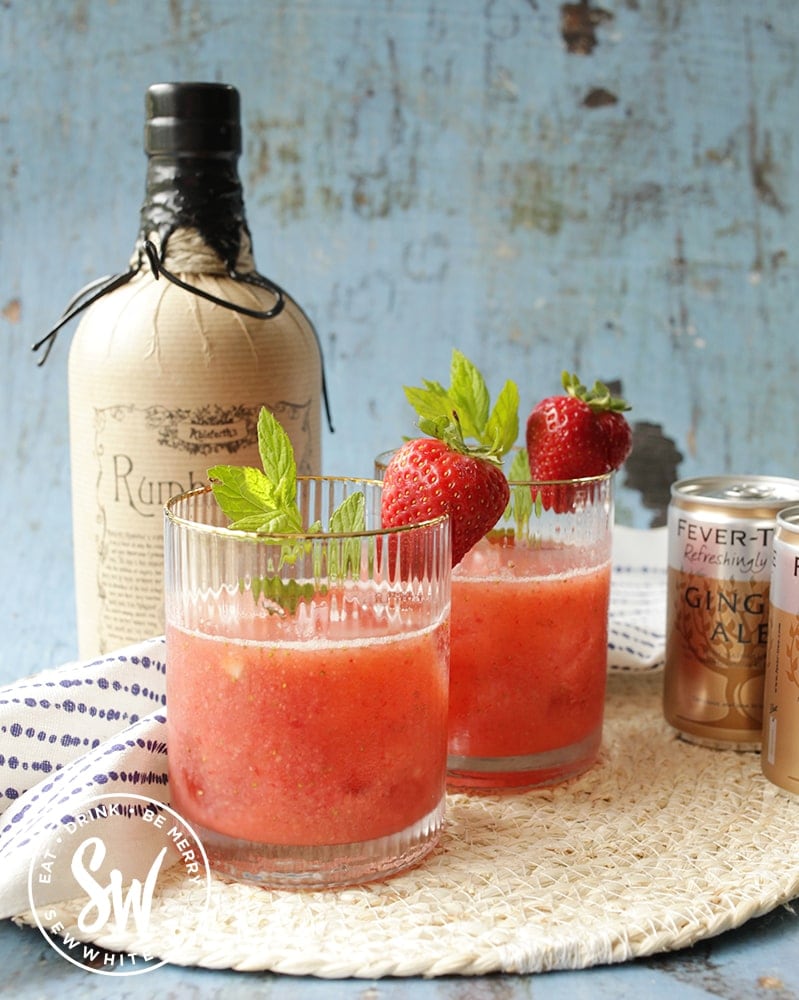 gold edged tumblers for cocktails with strawberry rum cocktail