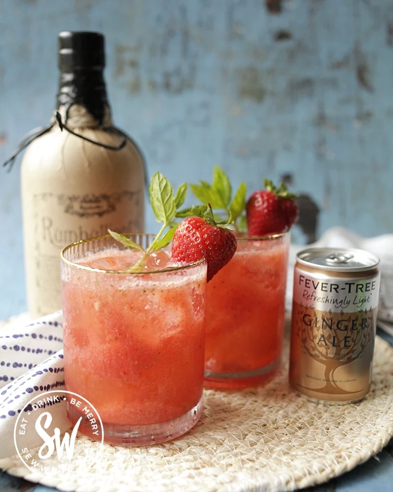 East Strawberry rum cocktail with a bottle of rumbullion in the background