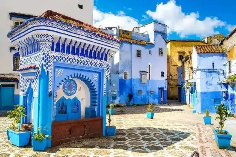 Scenic view of Chefchaouen, Morocco, showcasing its iconic blue buildings and mountainous backdrop for Custom Morocco Tours.