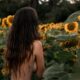 photo of topless woman near sunflowers